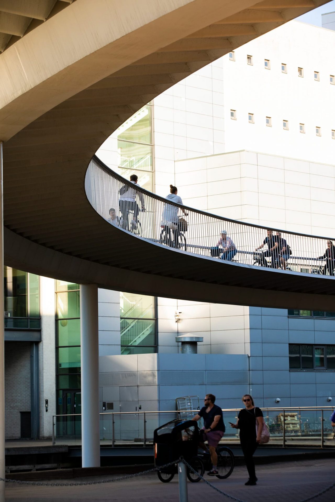 People ride on a bicycle bridge.